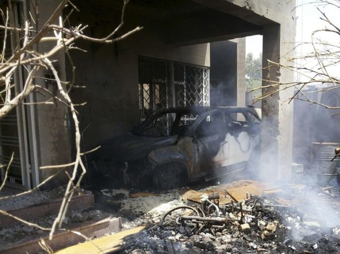 Smoke rises from debris and a burnt car after a house was destroyed in a bomb attack in Fallujah, west of Baghdad July 19, 2014. The shelling of the city of Fallujah on Saturday killed 13 people and injured 17 others, according to police. Picture taken July 19, 2014. REUTERS/Stringer (IRAQ - Tags: CIVIL UNREST POLITICS CONFLICT)