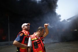 Palestinian firefighters participate in efforts to put out a fire at Gaza's main power plant, which witnesses said was hit in Israeli shelling, in the central Gaza Strip July 29, 2014. Israeli tank fire hit the fuel depot of the Gaza Strip's only power plant on Tuesday, witnesses said, cutting electricity to Gaza City and many other parts of the Palestinian enclave of 1.8 million people.An Israeli military spokeswoman had no immediate comment and said she was checking the report. Israel launched its Gaza offensive on July 8, saying its aim was to halt rocket attacks by Hamas and its allies. REUTERS/Mohammed Salem (GAZA - Tags: POLITICS CIVIL UNREST ENERGY)