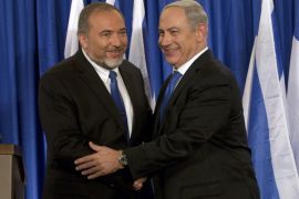 FILE - In this Oct. 25, 2012 file photo, Israeli Prime Minister Benjamin Netanyahu, right, and Foreign Minister Avigdor Lieberman shake hands in front the media after giving a statement in Jerusalem. Israel’s foreign minister says he is ending his political alliance with Prime Minister Benjamin Netanyahu. Lieberman told a news conference Monday, July 7, 2014 that he and Netanyahu have “substantial” differences. Despite the decision, Lieberman’s Yisrael Beitenu party will remain in the governing coalition, and Lieberman will remain as foreign minister. (AP Photo/Bernat Armangue, File)