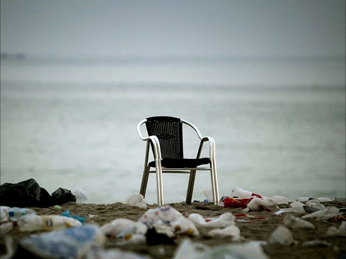 epa04276792 A lonely chair stands amid the litter scattered over the Orzan beach after the celebration of the Bonfires of Saint John in A Coruna, northwestern Spain, 24 June 2014. The Saint John bonfires are a popular annual event in Spain, especially in Catalonia and Galicia. EPA