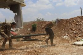 Rebel fighters carry a weapon as they walk towards their position in the town of Morek in Hama province July 20, 2014. Picture taken July 20, 2014. REUTERS/Badi Khlif (SYRIA - Tags: POLITICS CIVIL UNREST CONFLICT)