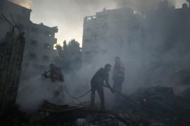 Palestinian firefighters try to extinguish a fire following what witnesses said was an Israeli air strike on a building in Gaza City July 24, 2014. Gazan authorities said Israeli forces shelled a shelter at a U.N.-run school on Thursday, killing at least 15 people as the Palestinian death toll in the conflict climbed over 750 and attempts at a truce remained elusive. The Israeli military said its troops were fighting gunmen from Hamas, which runs Gaza, in the area and that it was investigating the incident. Hamas fired rockets at Tel Aviv and said its gunmen carried out a lethal ambush on Israeli soldiers in north Gaza. REUTERS/Suhaib Salem (GAZA - Tags: POLITICS CIVIL UNREST)