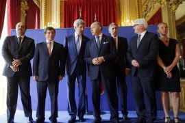 U.S. Secretary of State John Kerry, third from left, stands with from left, Qatari Foreign Minister Khaled al-Attiyah, Turkish Foreign Minister Ahmet Davutoglu, French Foreign Minister Laurent Fabius, British Foreign Secretary Philip Hammond, German Foreign Minister Frank-Walter Steinmeier and Italian Foreign Minister Federica Mogherini after their meeting regarding a cease-fire between Hamas and Israel in Gaza, Saturday, July 26, 2014, at the foreign ministry in Paris, France. With a 12-hour humanitarian cease-fire in Gaza Saturday, Kerry is continuing with efforts to reach a longer truce between Israel and Hamas. (AP Photo/Charles Dharapak, Pool)