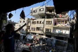 Palestinians inspect the rubble of a house after it was hit by an Israeli missile strike in Gaza City, Thursday, July 10, 2014. Israel dramatically escalated its aerial assault in Gaza Thursday, hitting hundreds of Hamas targets as its missile defense system once again intercepted rockets aimed at the country’s heartland. (AP Photo/Hatem Moussa)