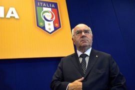In this picture taken Friday, July 25, 2014, Carlo Tavecchio attends an assembly of the National Amateur League in Rome. FIFA has asked the Italian football federation to open an investigation into alleged racist comments made by FIGC presidential candidate Carlo Tavecchio. "Media reports concerning alleged racist comments by one of the presidential candidates for the Italian FA have alerted FIFA's Task Force against racism and discrimination and its chairman Jeffrey Webb," a statement by world football's governing body said on Monday, July 28, 2014. Amateur leagues president Tavecchio sparked outrage on Friday when he discussed the presence of foreign players in Italy. Using a hypothetical name, he said, "In England they select players based on professionalism, whereas we say that 'Opti Poba' is here, he was eating bananas before and now he's starting for Lazio and that's OK." (AP Photo/Daniele Leone, LaPresse)