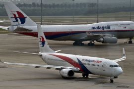 (FILES)-- A file photo taken on June 17, 2014 shows a Malaysia Airlines Boeing-737 plane taxiing past a 747 (back) from the same company at the Kuala Lumpur International Airport in Sepang. Malaysia Airlines said on July 17, 2014 that it had "lost contact" with one of its passenger planes whose last known position was over Ukraine. "Malaysia Airlines has lost contact of MH17 from Amsterdam," the airline, still reeling from the disappearance of flight MH370, said on its Twitter account. AFP PHOTO / Manan VATSYAYANA