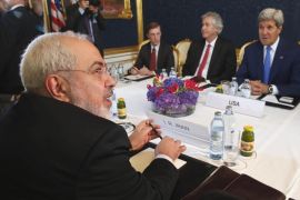 Iran's Foreign Minister Javad Zarif, foreground, holds a bilateral meeting with US Secretary of State John Kerry background right, on the second straight day of talks, in Vienna, Austria, Monday July 14, 2014. Secretary of State John Kerry continued in-depth discussions Monday with Iran's top diplomat in a bid to advance faltering nuclear negotiations, with a deadline just days away for a comprehensive agreement. (AP Photo/Jim Bourg, Pool)