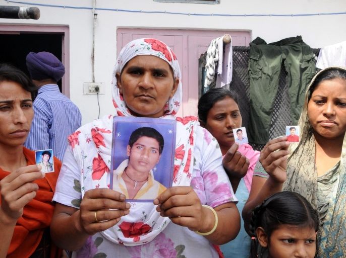 Relatives show photographs of Indian youth stuck in Iraq, in Amritsar, India, 26 June 2014. According to reports, some 120 Indians are stuck in Iraq owing to the unrest.