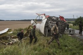 Pro-Russian fighters at the crash site of a Malaysia Airlines passenger jet near the village of Hrabove, Ukraine, Friday, July 18, 2014. Representatives of the OSCE (Organization for Security and Co-operation in Europe) delegation have arrived at the crash site with four Ukrainian experts to begin an investigation into the downing of the Malaysia Airlines plane on Thursday and the deaths of all its passengers and crew. (AP Photo/Evgeniy Maloletka)