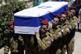 Israeli soldiers carry the flag-draped coffin of their comrade Guy Algranati during his funeral in Tel Aviv July 31, 2014. Algranati was killed on Wednesday by a booby trap detonated as he and 2 other soldiers uncovered a tunnel shaft, the army said. Prime Minister Benjamin Netanyahu, facing international alarm over a rising civilian death toll in Gaza, said on Thursday he would not accept any ceasefire that stopped Israel completing the destruction of militants' infiltration tunnels. Gaza officials say at least 1,394 Palestinians, most of them civilians, have been killed in the battered territory and nearly 7,000 wounded. Fifty-six Israeli soldiers have been killed in Gaza clashes and more than 400 wounded. Three civilians have been killed by Palestinian shelling in Israel. REUTERS/Nir Elias (ISRAEL - Tags: CIVIL UNREST MILITARY POLITICS OBITUARY CONFLICT)
