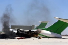 A picture made available on 19 July 2014 shows damaged planes and smoke rises following clashes between rival militias at the main airport of Tripoli, Libya, 16 July 2014. Clashes erupted between rival militias in the Libyan capital Tripoli on 18 July 2014 hours after they had reached a truce deal. The fighting erupted around the main airport in the capital, Dubai-based broadcaster Al-Arabiya said. No casualties were reported. An Islamist militia from the town of Misrata, 200 km west of Tripoli, has been engaged since 13 July in fighting against an armed group from the north-western town of Zintan, which has controlled the airport since the overthrow of Gaddafi in 2011.