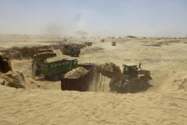 Bulldozers and trucks work on an upgrade project for the Suez Canal, in Ismailia, Egypt, Tuesday, Aug. 12, 2014. Egypt's president Abdel-Fattah el-Sissi inaugurated the digging of a new section of the Suez Canal, 35-km (22 mile), a $4 billion military-led project to expand a key corridor of world trade that he says will be finished next year. The canal was opened for navigation in 1869. (AP Photo/Amr Nabil)