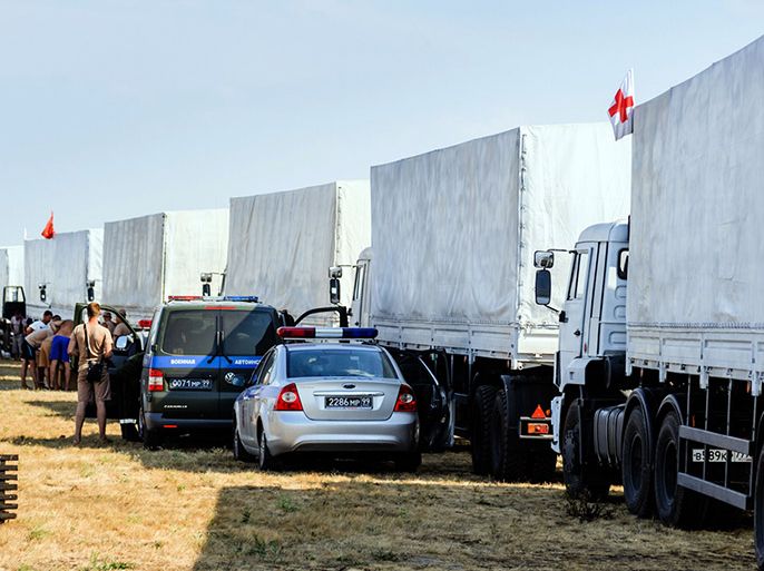 Trucks of Russian humanitarian convoy wait at the location outside Voronezh some 400 km outside Moscow on August 13, 2014. A massive Russian aid convoy rumbled towards Ukraine's border on August 13 as Kiev vowed to block what it feared could be a "Trojan horse" bringing military assistance to pro-Kremlin rebels fighting a bloody insurgency in the east. Russian television images showed a line of nearly 300 lorries moving through the countryside, covered with white tarpaulin and stretching over almost three kilometres (two miles). AFP