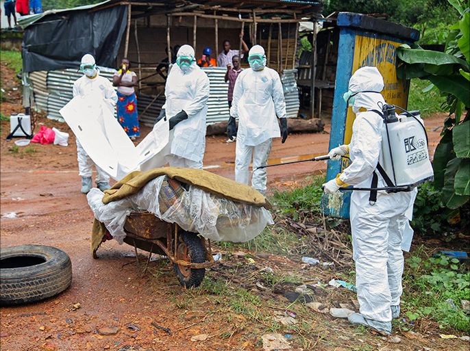 epa04346216 Liberian nurses disinfect an Ebola victim lying on a street in Virginia on the outskirts of the capital Monrovia, Liberia, 08 August 2014. Following a two day meeting in their headquarters in Geneva the World Health Organization (WHO) declared the Ebola outbreak in West Africa is now an international health emergency. Liberia's president has declared a state of emergency in an attempt to stop the Ebola outbreak which continues to spread across West Africa according to local newspaper reports. According to statistics from the World Health Organisation (WHO), 932 patients have died from Ebola in West Africa with most of the latest deaths reported in Liberia. EPA/AHMED JALLANZO