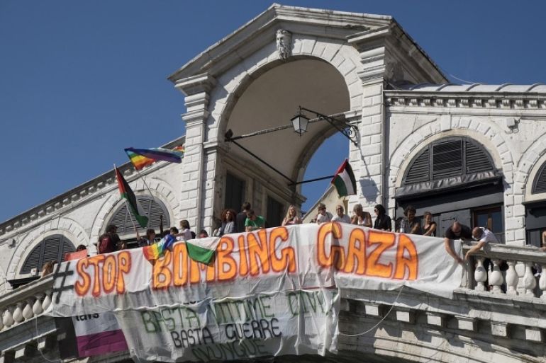 VENICE, ITALY - JULY 16: Pro Palestinian protesters display a large banner from Rialto Bridge during a rally against the bombing of Gaza on July 16, 2014 in Venice, Italy. After the recent unrest there have been several flash mobs, rallies and protests in different parts of Italy asking to stop the bombing of Gaza.