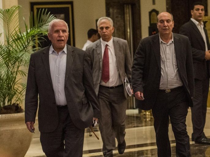 Head of the Palestinian delegation Azzam al-Ahmed (L) and others members of the delegation arrive to the hotel after a meeting with Egyptians seniors intelligence in Cairo August 11, 2014. A fresh 72-hour ceasefire between Israel and Hamas came into effect in Gaza Monday, paving the way for talks in Egypt aimed at a durable end to a month-long conflict that has wreaked devastating bloodshed. AFP PHOTO / KHALED DESOUKI