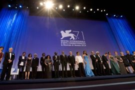 Members of the juries of different sections of the 71st edition of the Venice Film Festival stand on the stage during the opening ceremony of the Festival in Venice, Italy, Wednesday, Aug. 27, 2014. (AP Photo/Andrew Medichini)