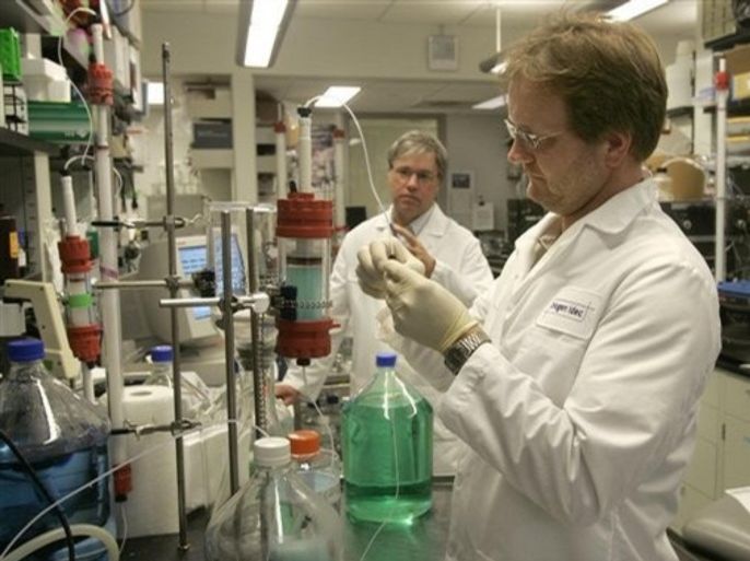 In this July 23, 2007 file photo, Biogen Idec Inc. principle scientist Darren Baker, right, and scientist John Eldridge work on protein purification at a laboratory at the company's Cambridge, Mass. headquarters. Biotechnology company Biogen Idec Tuesday, July 22, 2008, says profit rose 11 percent on increasing sales of its multiple sclerosis treatments Avonex and Tysabri.