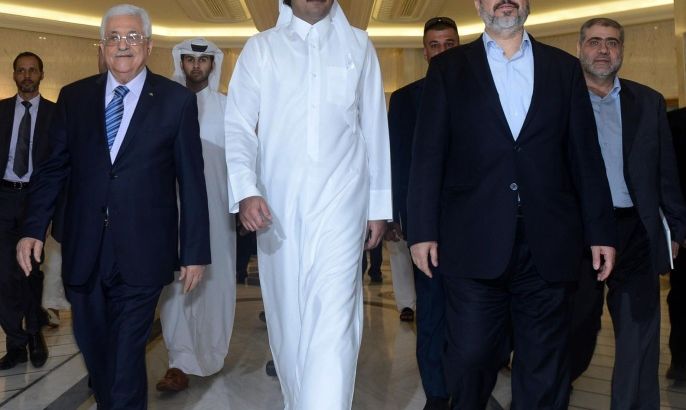 DOHA, QATAR - AUGUST 21: In this handout image supplied by the Palestinian Press Office (PPO), President Mahmoud Abbas (L) walks with the Emir of Qatar Sheikh Tamim (C) and leader of Hammas Khaled Meshal (R) during their meeting on August 21, 2014 in Doha, Qatar. In their meeting they are thought to be discussing amongst other things, the latest cease-fire proposal advanced by Egypt.