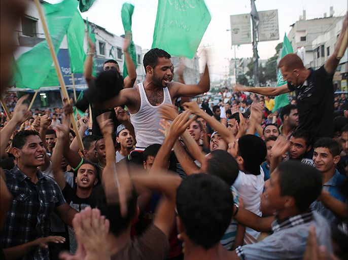 Palestinians gather in the streets to celebrate after a deal had been reached between Hamas and Israel over a long-term end to seven weeks of fighting in the Gaza Strip on August 26, 2014 in Rafah in the southern of Gaza Strip