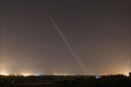 Rockets launched from the Gaza Strip towards Israel is seen (at right) as a rocket by the Iron Dome anti-missile system (at left) is fired to intercept them, before a five-day ceasefire was due to expire, August 19, 2014. A ceasefire in the Gaza
