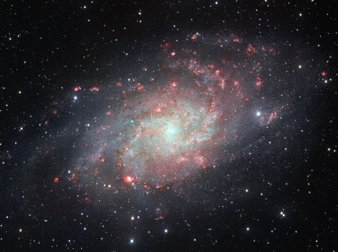 An undated handout image provided by the European Southern Observatory (ESO) on 06 August 2014 shows a snap by the VLT Survey Telescope (VST), at ESO's Paranal Observatory in Chile, that shows the galaxy Messier 33, often called the Triangulum Galaxy. This nearby spiral, the second closest large galaxy to our own galaxy, the Milky Way, is packed with bright star clusters, and clouds of gas and dust. This picture is amongst the most detailed wide-field views of this object ever taken and shows the many glowing red gas clouds in the spiral arms with particular clarity. EPA/ESO / HANDOUT EDITORIAL USE ONLY