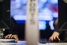 In this July 11, 2014 photo, the hand of Kim "ViOLet" Dong Hwan, left, of South Korea, types on a keyboard as the hand of Steven "Baer" Baeringer, of Coral Springs, Fla., uses a mouse while separated by a divider as they compete against each other in the Red Bull Battle Grounds "StarCraft II" video game tournament in Atlanta. Hwan is one of two competitors from South Korea who were granted professional athlete visas by the U.S. and now live and train together in Atlanta. Professional gamers and amateurs from the U.S., Canada, China, South Korea and Australia competed in the three day tournament of the science-fiction strategy video game "StarCraft II." The contestants wear special noise-canceling headphones while spectators cheer in a live arena as announcers provide the play-by-play. Choi "Bomber" Ji Sung, of South Korea, won the the 128 player bracket and the $8,000 prize purse advancing to the Battle Grounds Grand Final which takes place September 20th–21st in Washington. (AP Photo/David Goldman)