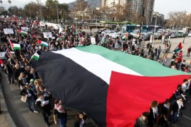 Demonstrators hold an oversize Palestinian flag during a protest of members of the Palestinian community against Israeli attacks in the Gaza Strip, in Santiago de Chile, Chile, 02 August 2014. Hundreds of people participated in the rally condemning the Israeli military operations in Gaza.
