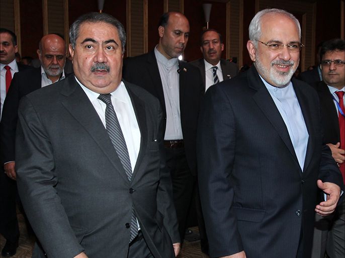 Iranian Minister of Foreign affairs Mohammad Javad Zarif (R) and Hoshyar Zebari (L) the Iraqi Minister of Foreign Affairs walk to give a press conference at the Iraqi Ministry of Foreign Affairs in Baghdad on August 24, 2014