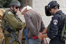 Members of the Israeli security forces arrest suspected Palestinians following the shooting of an Israeli police officer in an attack near the southern West Bank city of Hebron the previous week, as they conduct house raids in the village of Der Samet to find the culprits on April 24, 2014. The incident at the start of the Jewish Passover holiday was the first deadly attack on an Israeli in the occupied West Bank since the start of the year, and came as tensions were soaring over the near-breakdown of US-brokered peace talks. AFP PHOTO / HAZEM BADER