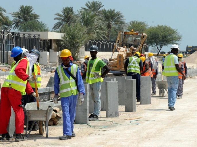 Foreign laborers work at the construction site for a new corniche road in Doha, Qatar, 04 October 2013. Recent media reports said immigrant workers on projects for the World Cup 2022 have been subject to abuse and harsh working conditions. An investigation by Britain's Guardian newspaper said 44 Nepalis had died in Qatar from 04 June to 08 August.