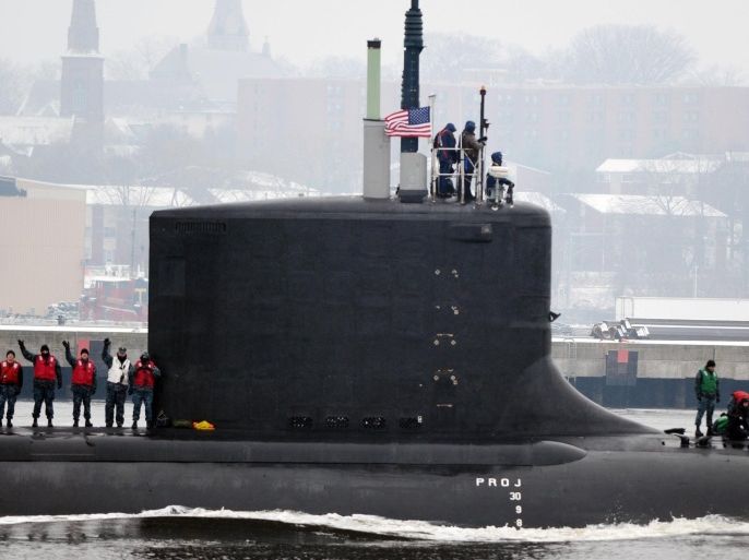 Crew on the deck of the U.S. Navy Virginia class attack submarine USS Minnesota (SSN 783) wave to family on the Groton bank as the sub transits the Thames River en-route to the navy submarine base in Groton, Conn. Friday, Jan. 10, 2014. The Minnesota, the 10th boat built in the class, was commissioned September 7th in Norfolk, Virginia and arrives today to be homeported in Groton. (AP Photo/The Day, Sean D. Elliot) MANDATORY CREDIT: THE DAY/SEAN D. ELLIOT