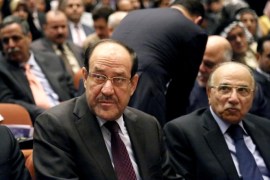 Iraqi Prime Minister Nouri al-Maliki, center, attends the first session of parliament in the heavily fortified Green Zone in Baghdad, Iraq, Tuesday, July 1, 2014. Iraq's new parliament ended its inaugural session Tuesday after failing to make any progress in choosing a new prime minister even as the country faces a militant blitz that threatens to rip it apart and a spike in violence that made June the deadliest month in at least two years. (AP Photo/Karim Kadim)