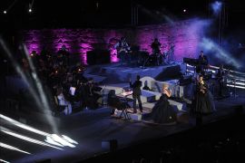 Franch singers Claire Péro (R) and Maeva Méline (L) perform in the "Mozart, l'opéra rock" during the closing of the 50th session of the International Carthage Festival on August 16, 2014 at the Roman theater of Carthage near Tunis. AFP PHOTO / FETHI BELAID