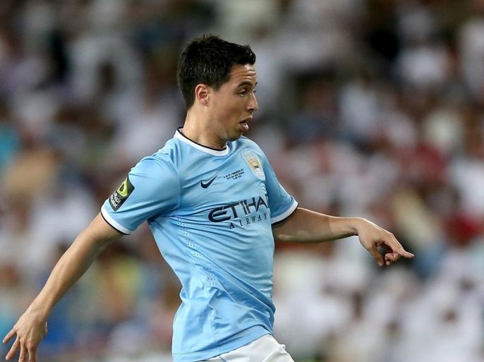 AL AIN, UNITED ARAB EMIRATES - MAY 15: Samir Nasri of Manchester City in action during the friendly match between Al Ain and Manchester City at Hazza bin Zayed Stadium on May 15, 2014 in Al Ain, United Arab Emirates.