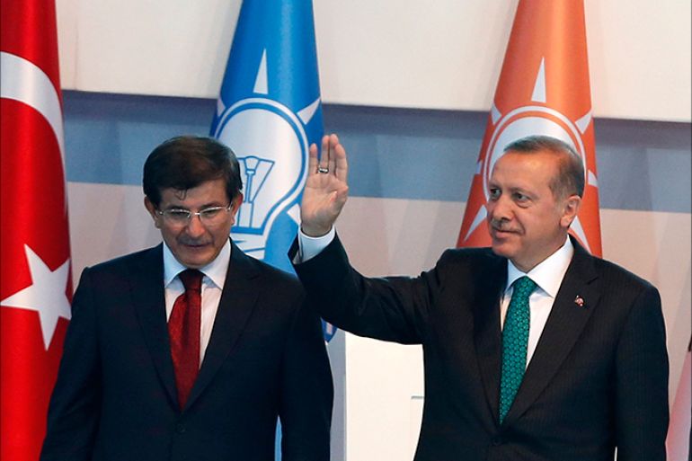 Turkey's President-elect Tayyip Erdogan (R) and incoming prime minister Ahmet Davutoglu leave the stage together during the Extraordinary Congress of the ruling AK Party (AKP) in Ankara August 27, 2014. Erdogan said on Wednesday he would