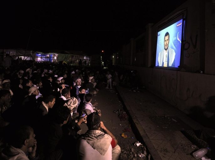 Followers of the Shiite Houthi movement watch rebel commander Abdel-Malik al-Houthi delivering a speech on a television projection installed at a sit-in square in Sanaa, Yemen, 26 August 2014. Reports state that Shiite leader Abdel-Malik al-Houthi demanded the reinstatement of a fuel subsidy program, the dismissal of the current government and a partnership in the political decision making process, before his followers encampments in Sanaa disband.