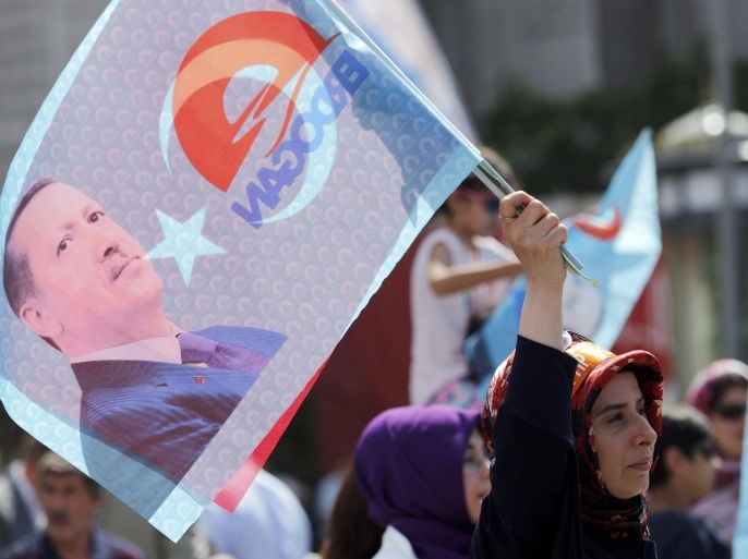A supporter waves a flag during a gathering in support of Turkey's Prime Minister and presidential candidate Tayyip Erdogan in Istanbul August 8, 2014. Erdogan is set to secure his place in history as Turkey's first popularly-elected president on Sunday, but his tightening grip on power has polarised the nation, worried Western allies and raised fears of creeping authoritarianism. REUTERS/Murad Sezer (TURKEY - Tags: POLITICS ELECTIONS)