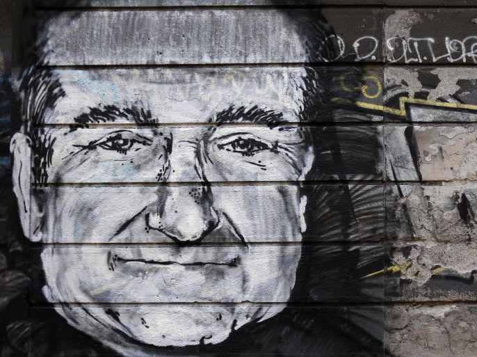 A man runs past a mural on a wall depicting US actor Robin Williams, in Belgrade, Serbia, Wednesday, Aug. 13, 2014. It was announced Monday that the actor had been found dead at his home in California. (AP Photo/Darko Vojinovic)