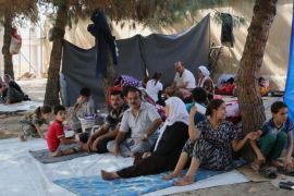 Displaced Iraqis from the Yazidi community gather at a park near the Turkey-Iraq border at the Ibrahim al-Khalil crossing, as they try to cross to Turkey, in Zakho, 300 miles (475 kilometers) northwest of Baghdad, Iraq, Friday, Aug. 15, 2014. The U.N. this week declared the situation in Iraq a "Level 3 Emergency" — a decision that came after some 45,000 members of the Yazidi religious minority were able to escape from a remote desert mountaintop where they had been encircled by Islamic State fighters. The extremist group views them as apostates and had vowed to kill any who did not convert to Islam. (AP Photo/Khalid Mohammed)