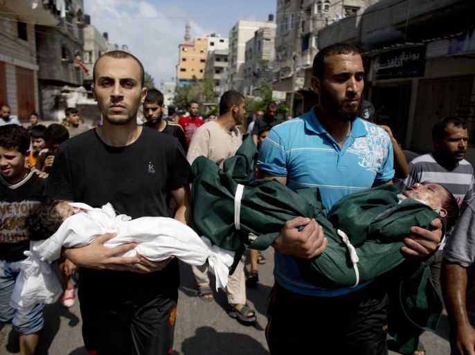 Al-Bakin family members carry the bodies of three year-old Kamal and four month-old Asthm during their funeral in Gaza City, Monday, Aug. 5, 2014. The children were killed along with another family member in an Israeli missile strike on their home in the Shati refugee camp, Gaza City, on Monday. (AP Photo/Dusan Vranic)