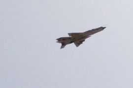 In this image made from AP video on Friday, Aug. 1, 2014, a MiG fighter jet flies over Benghazi, Libya. MiG fighter jets, reportedly under the control of renegade general, Khalifa Hifter, struck in retaliation the bases of Islamic militias in Benghazi on Friday, as a coalition of Islamic militias over the past week captured a number of army bases in Benghazi, driving out troops and police and seizing large weapon stores. (AP Photo/AP video)