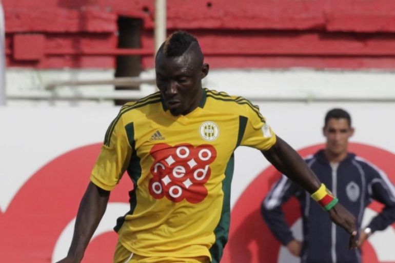 JS Kabylie striker Albert Ebosse, from Cameroon, runs with the ball during the Algeria Cup final soccer match against MC Alger in Algiers May 1, 2014. The Confederation of African Football (CAF) have called for "exemplary sanctions" following the death of JS Kabylie striker Albert Ebosse, who was killed by a projectile thrown from the crowd in an Algerian league match on Saturday. Picture taken May 1, 2014. REUTERS/LOUAFI LARBI ( ALGERIA - Tags: SPORT SOCCER)