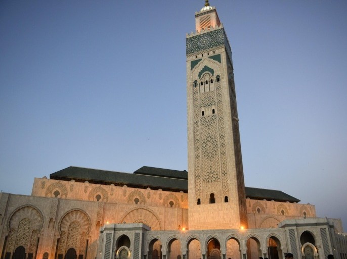 People walk outside the Hassan II Mosque, the third largest mosque in the world, in Casablanca, Morocco, 22 December 2013. The 30-square kms Hassan II Mosque was built in 1993 looking out to the Atlantic Ocean. It accommodates more than 100,000 worshippers.