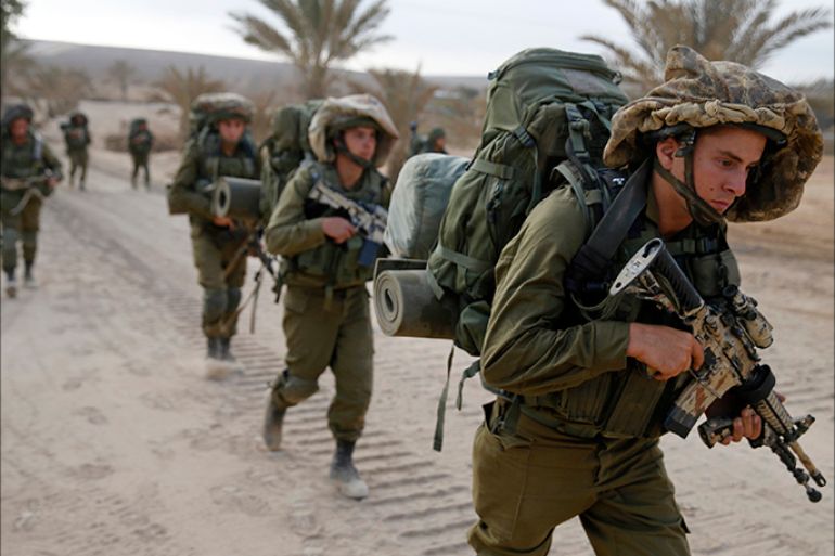 Israeli soldiers walk outside the Gaza Strip as they proceed towards Gaza August 2, 2014. Hamas claimed responsibility on Saturday for a deadly Gaza Strip ambush in which an Israeli army officer may have been captured, but said the incident likely preceded and therefore had not violated a U.S.- and U.N.-sponsored truce. Palestinian officials say 1,653 Gazans, mostly civilians, have been killed. Sixty-three Israeli soldiers have been killed, and Palestinian shelling has killed three civilians in Israel. Israel launched a Gaza air and naval offensive on July 8 following a surge of cross-border rocket salvoes by Hamas and other Palestinian guerrillas, later escalating into ground incursions centred along the tunnel-riddled eastern frontier of the enclave but often pushing into residential areas. REUTERS/Baz Ratner (ISRAEL - Tags: CIVIL UNREST MILITARY POLITICS CONFLICT)