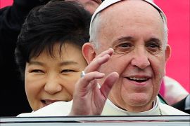 epa04352720 Pope Francis (R) waves his hand as South Korean president Park Geun-Hye (L, back) smiles upon his arrival at Seoul Airport in Seongnam City, South Korea, 14 August 2014. Pope Francis arrived in South Korea for a five-day visit to attend the Asia Youth Day in Daejeon. The pontiff is also expected to lead the beatification ceremony of 124 Korean martyrs. EPA/SSONG KYUNG-SEOK/POOOL BEST QUALITY AVAILABLE