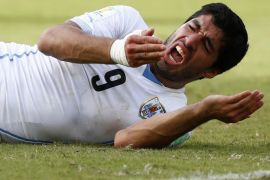 Uruguay's Luis Suarez reacts after clashing with Italy's Giorgio Chiellini during their 2014 World Cup Group D soccer match at the Dunas arena in Natal in this June 24, 2014 file photo. Suarez has finally apologised for biting Chiellini during the World Cup match and vowed there would never be a repeat of the incident. REUTERS/Tony Gentile/Files (BRAZIL - Tags: SPORT SOCCER WORLD CUP)