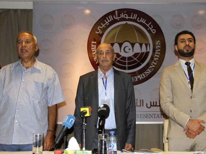 Aguila Saleh Iissa (C) stands at attention after being elected as president of the newly elected Libya's House of Representatives in Tobruk August 5, 2014. Libya's new parliament appealed for national unity at its first formal session on Monday as rival armed factions battled for dominance of a country struggling to hold itself together three years after the fall of Muammar Gaddafi. REUTERS/Stringer (LIBYA - Tags: POLITICS)