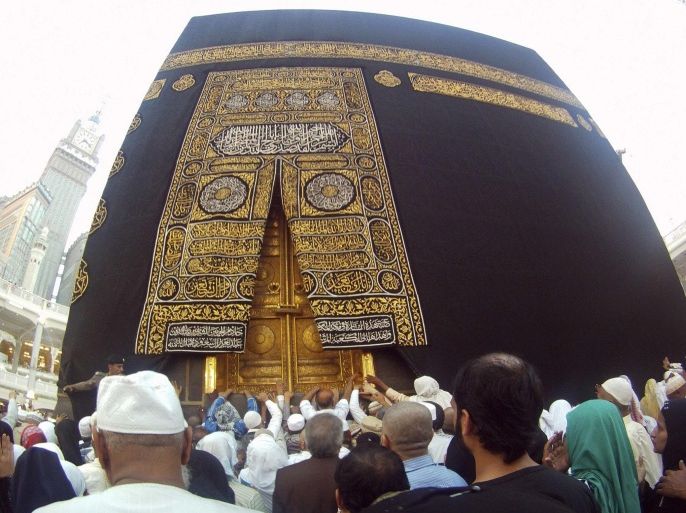 Muslims touch and pray at the door of the Kaaba, as well as touch and kiss the al-Hajr al-Aswad "Black Stone", during their Umrah Mawlid al-Nabawi pilgrimage, at the Grand Mosque in the holy city of Mecca January 14, 2014. Muslims mark Eid Mawlid al-Nabawi, or the birth of Prophet Mohammad, on Tuesday. REUTERS/Amr Abdallah Dalsh (SAUDI ARABIA - Tags: RELIGION ANNIVERSARY)