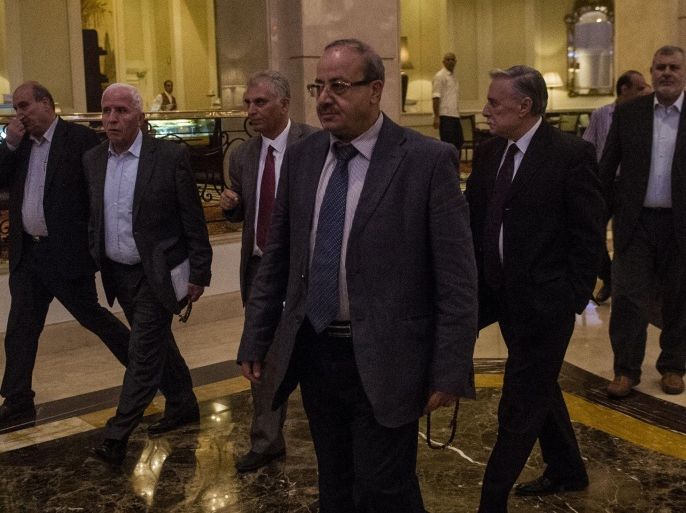 Head of the Palestinian delegation Azzam al-Ahmed (L) and others members of the delegation arrive to the hotel after a meeting with Egyptians seniors intelligence in Cairo late on August 11, 2014. A fresh 72-hour ceasefire between Israel and Hamas came into effect in Gaza Monday, paving the way for talks in Egypt aimed at a durable end to a month-long conflict that has wreaked devastating bloodshed. AFP PHOTO / KHALED DESOUKI